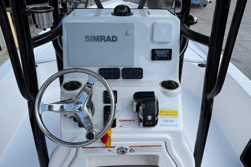 Slide: The Image of 2026 Blazer PureBay 2400 boat console with Simrad electronics and Suzuki controls. - 14