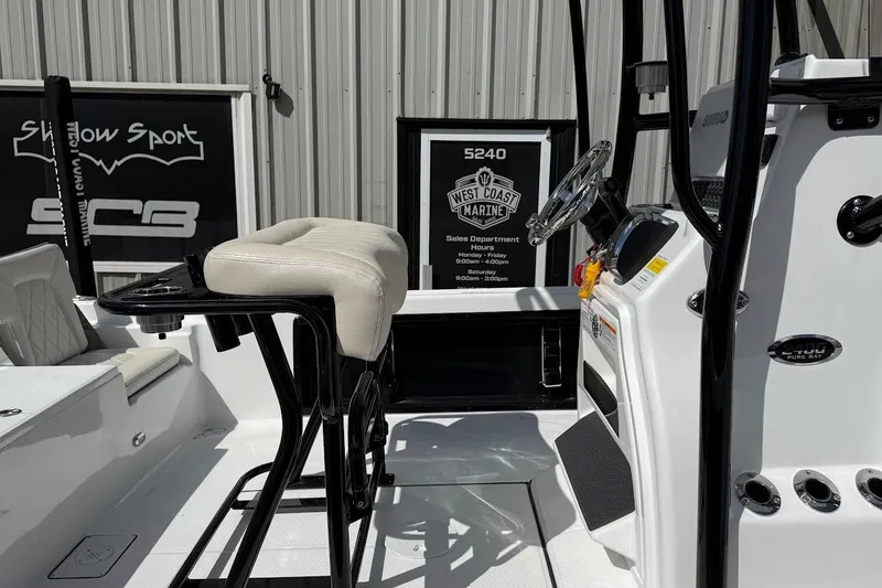 Slide: The Image of 2026 Blazer PureBay 2400 boat interior with steering console and seating. - 6