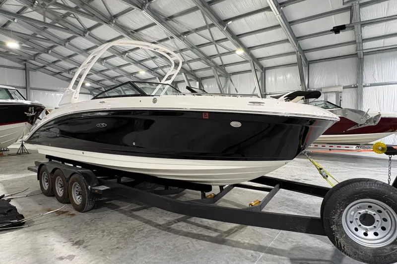 The Image of 2022 Sea Ray SDX 270 Outboard boat cruising on a scenic lake. - 0