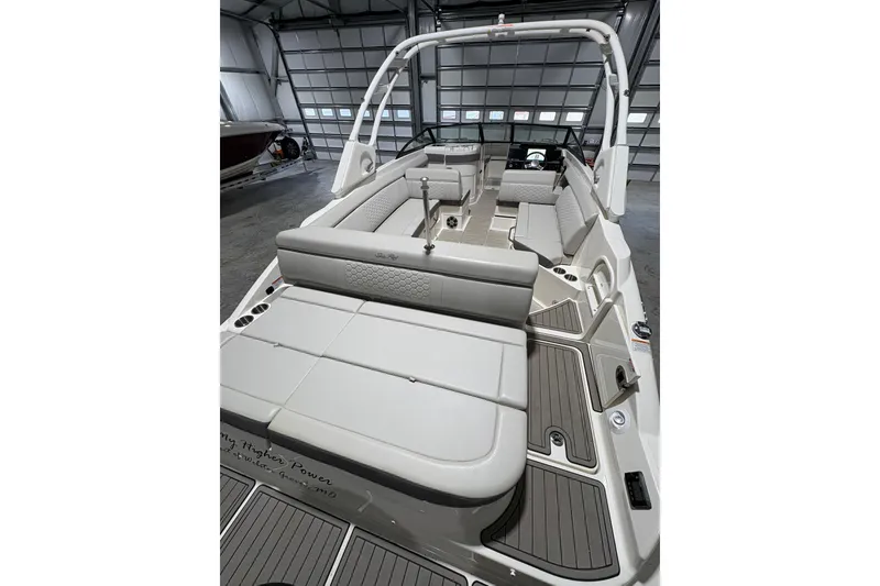 Slide: The Image of 2022 Sea Ray SDX 270 Outboard dashboard with steering wheel and navigation display. - 7
