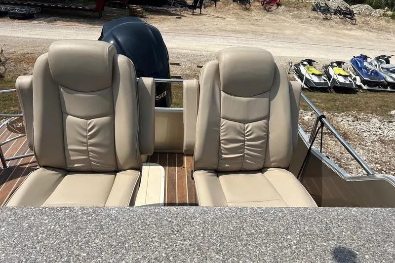 Slide: The Image of Beige leather seats on 2018 SunChaser 326 boat, with wooden deck and outdoor setting. - 10