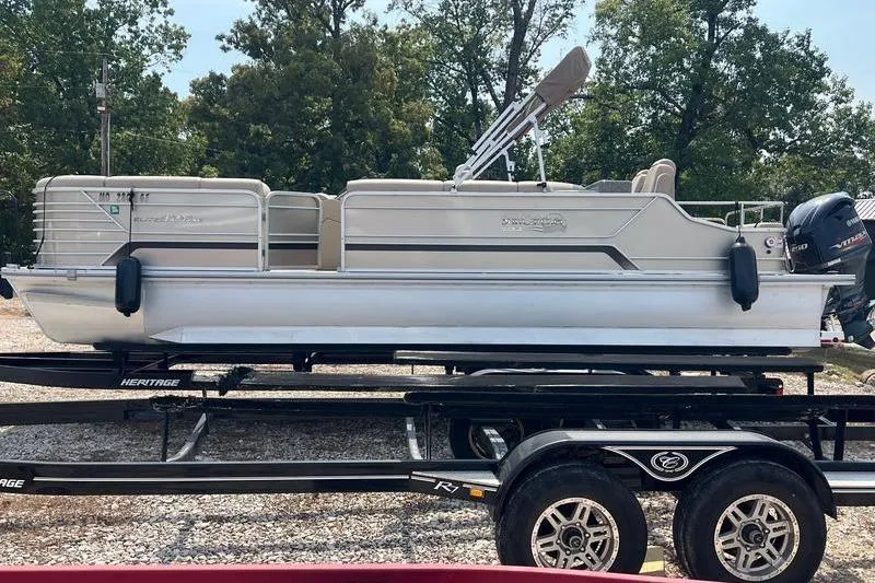 Slide: The Image of 2018 SunChaser 326 pontoon boat on trailer, parked outdoors. - 2
