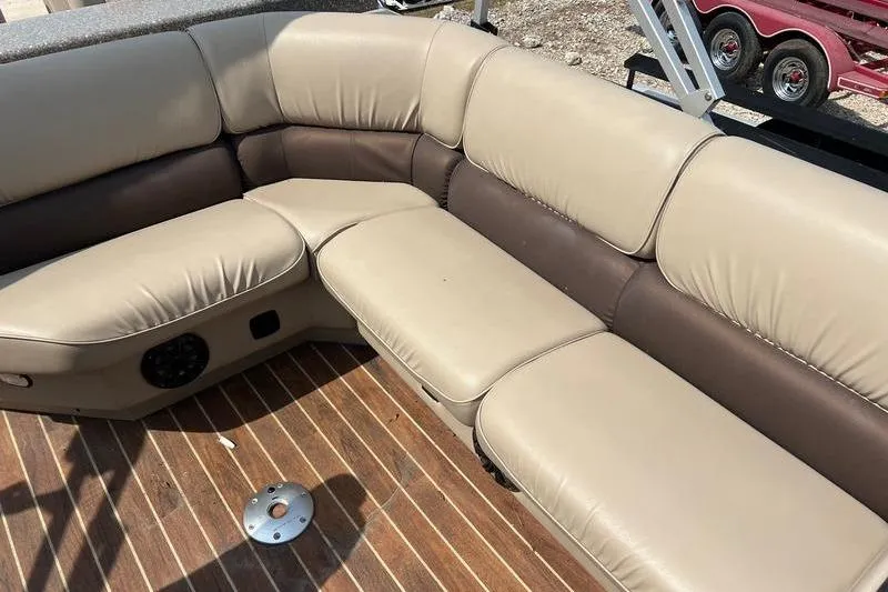 Slide: The Image of Luxurious seating on 2018 SunChaser 326 boat, featuring beige and brown upholstery with wood flooring. - 3