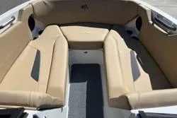 Slide: The Image of 2025 MasterCraft NXT22 boat interior with beige seating and modern design. - 11