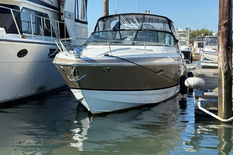 Slide: The Image of 2008 Formula 350 Sun Sport boat docked at marina, surrounded by other vessels. - 2