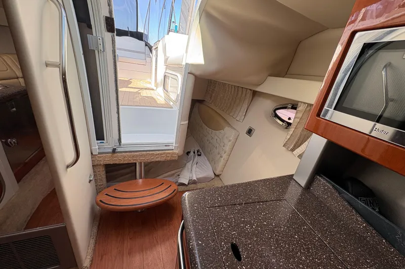 Slide: The Image of Interior of 2008 Formula 350 Sun Sport boat, featuring kitchenette and cabin access. - 22