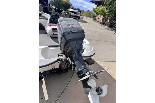 Slide: The Image of 1998 Nitro 700 LX DC boat with outboard motor, parked outdoors on a sunny day. - 5