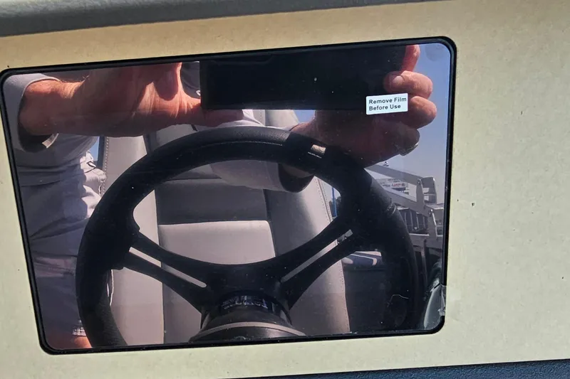 Slide: The Image of Reflection on Sun Tracker Party Barge 22 RF XP3 steering wheel, 2026 model. - 12