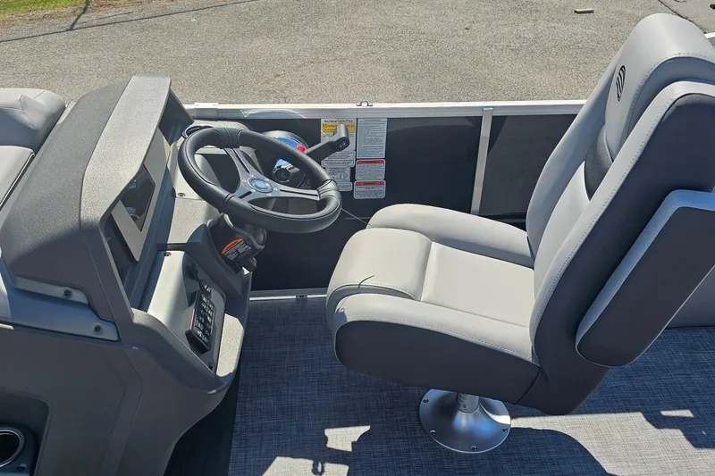 Slide: The Image of 2026 Sun Tracker Party Barge 22 RF XP3 helm with steering wheel and captain's chair. - 9