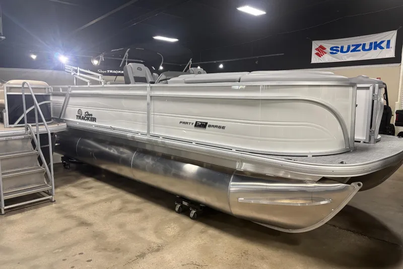 The Image of 2026 Sun Tracker Party Barge 22 RF XP3 pontoon boat displayed indoors. - 0