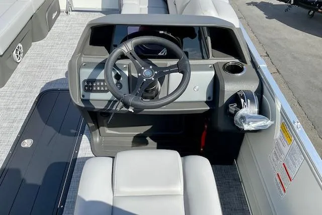 Slide: The Image of 2026 Sun Tracker Party Barge 22 RF XP3 helm with steering wheel and seating. - 12