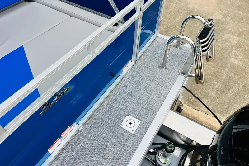 Slide: The Image of 2026 Sun Tracker Party Barge 22 RF DLX pontoon boat with blue exterior and stainless steel ladder. - 11
