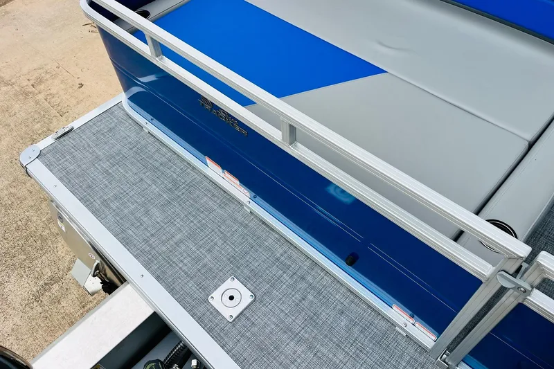 Slide: The Image of 2026 Sun Tracker Party Barge 22 RF DLX, blue and gray deck, sleek design. - 12