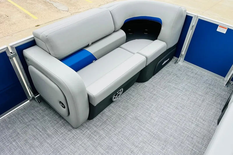 Slide: The Image of 2026 Sun Tracker Party Barge 22 RF DLX interior with gray seating and blue accents. - 14