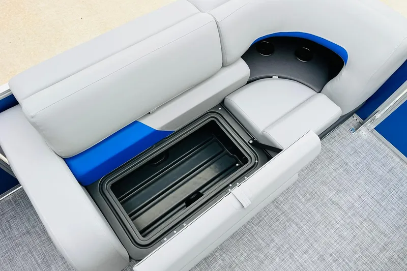Slide: The Image of Sun Tracker Party Barge 22 RF DLX 2026 interior with storage compartment and cup holders. - 16