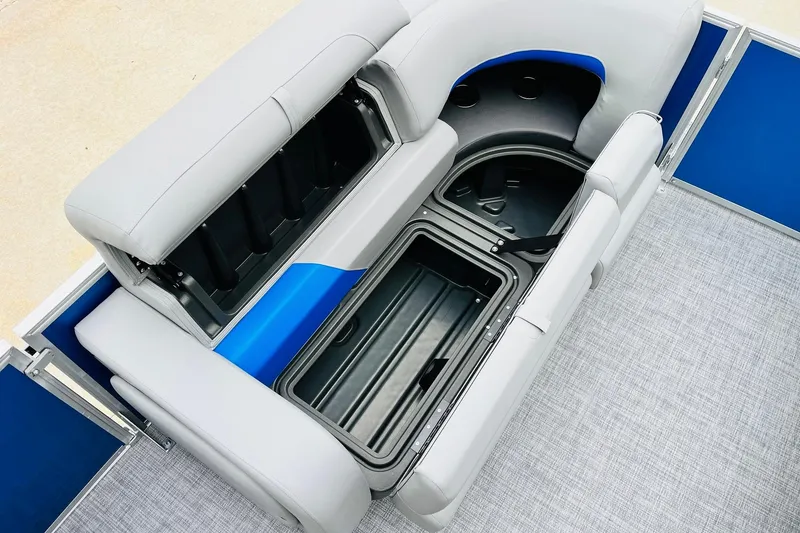 Slide: The Image of 2026 Sun Tracker Party Barge 22 RF DLX seating with storage compartments open. - 19