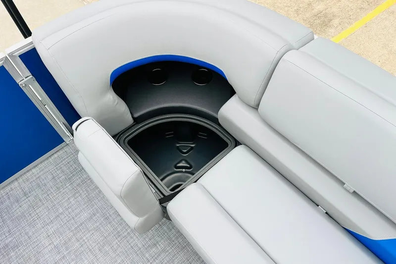 Slide: The Image of 2026 Sun Tracker Party Barge 22 RF DLX seating with storage compartment, featuring gray upholstery. - 23