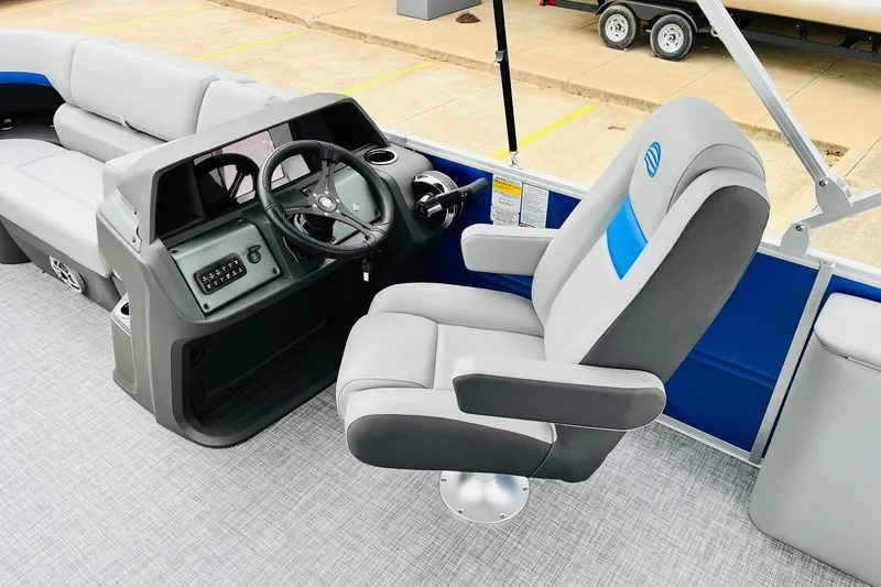 Slide: The Image of 2026 Sun Tracker Party Barge 22 RF DLX interior with captain's chair and steering console. - 31