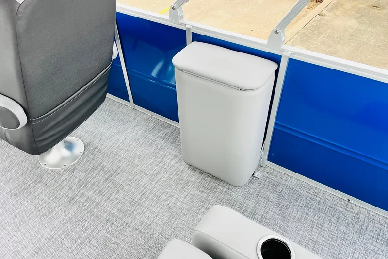 Slide: The Image of Interior of 2026 Sun Tracker Party Barge 22 RF DLX, featuring seating and blue paneling. - 36