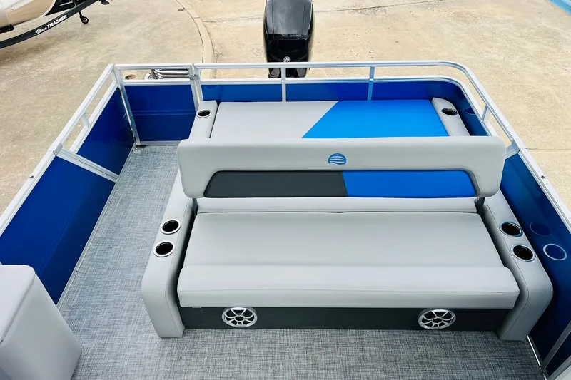 Slide: The Image of 2026 Sun Tracker Party Barge 22 RF DLX interior with blue and gray seating. - 38