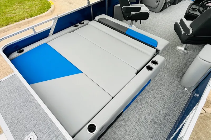 Slide: The Image of 2026 Sun Tracker Party Barge 22 RF DLX interior with gray and blue seating, cup holders. - 40