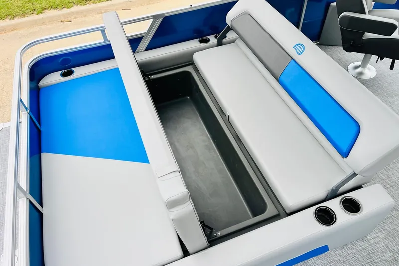 Slide: The Image of 2026 Sun Tracker Party Barge 22 RF DLX seating with storage compartment and cup holders. - 49