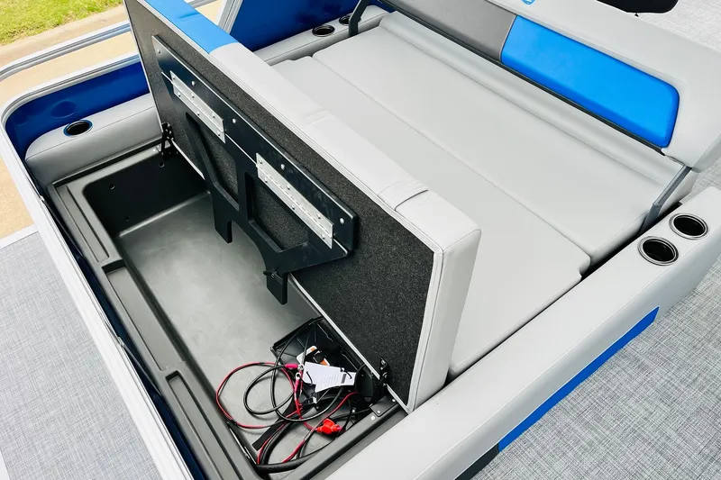 Slide: The Image of 2026 Sun Tracker Party Barge 22 RF DLX storage compartment with seating and cup holders. - 50