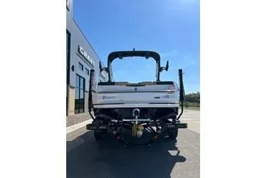 Slide: The Image of 2025 MasterCraft NXT20 boat rear view in a sunny outdoor setting. - 11