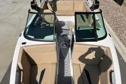 Slide: The Image of 2025 MasterCraft NXT20 boat interior with tan seating and open windshield. - 5