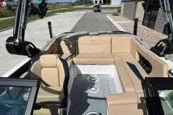 Slide: The Image of 2025 MasterCraft NXT20 boat interior with beige seating and modern design. - 8