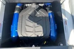 Slide: The Image of 2025 MasterCraft XT22 engine with blue components in a boat compartment. - 15
