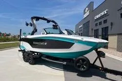 Slide: The Image of 2025 MasterCraft XT22 boat on trailer, parked outside dealership. - 19
