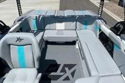 Slide: The Image of 2025 MasterCraft XT22 boat interior with gray and blue seating, showcasing modern design. - 20