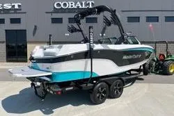 Slide: The Image of 2025 MasterCraft XT22 boat on trailer, parked outside dealership. - 7