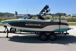 Slide: The Image of 2025 MasterCraft XT22 boat on trailer, side view, outdoors. - 9