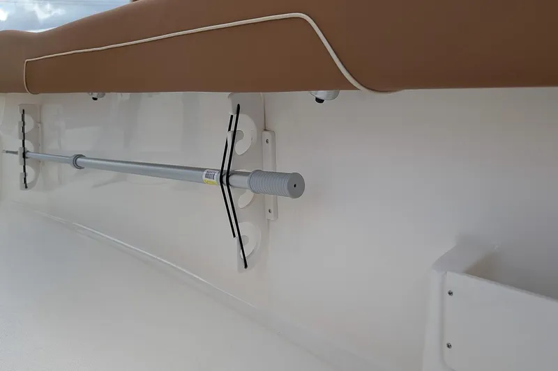 Slide: The Image of 2026 Key West 239 FSR boat interior detail with rod holder and cushioned seating. - 11