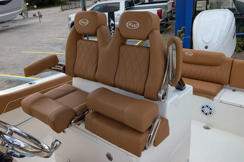 Slide: The Image of 2026 Key West 239 FSR boat with luxurious brown leather seating and chrome accents. - 12