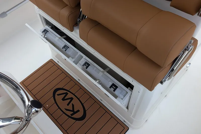 Slide: The Image of 2026 Key West 239 FSR boat interior with tan seating and storage compartments. - 13