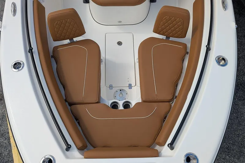 Slide: The Image of 2026 Key West 239 FSR boat interior with brown cushioned seating and white deck. - 19