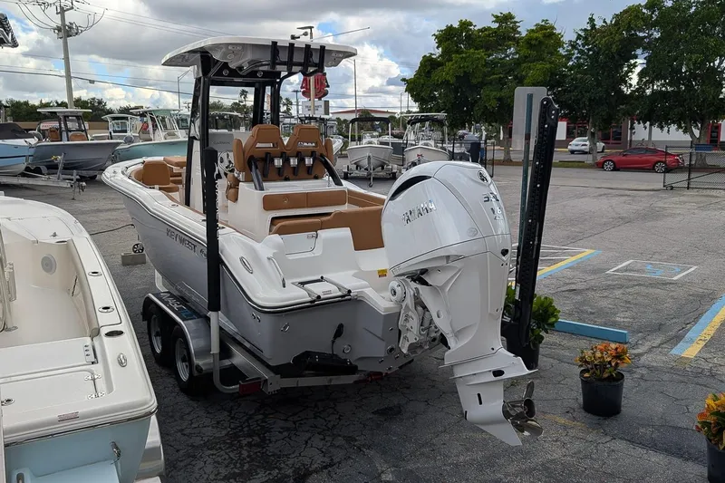 Slide: The Image of 2026 Key West 239 FSR boat with Yamaha engine on trailer in parking lot. - 2