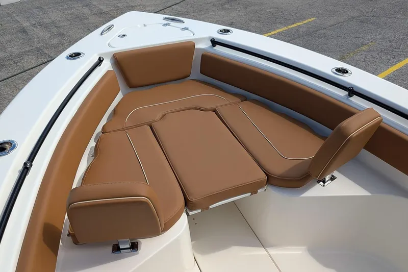 Slide: The Image of 2026 Key West 239 FSR boat with brown cushioned seating in the bow area. - 20