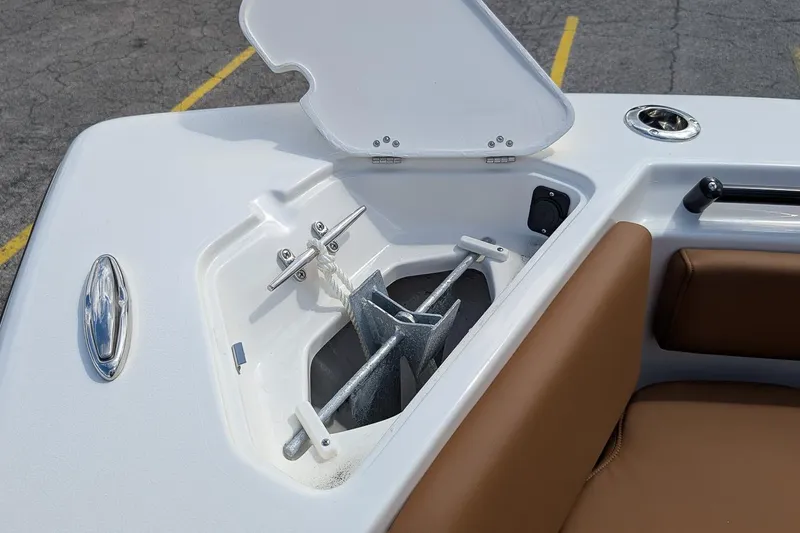 Slide: The Image of Open anchor compartment on 2026 Key West 239 FSR boat with brown seating. - 21