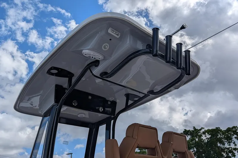 Slide: The Image of 2026 Key West 239 FSR boat T-top with rod holders against cloudy sky. - 23