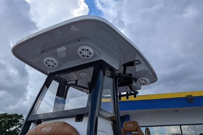 Slide: The Image of 2026 Key West 239 FSR boat with speakers and canopy under cloudy sky. - 24