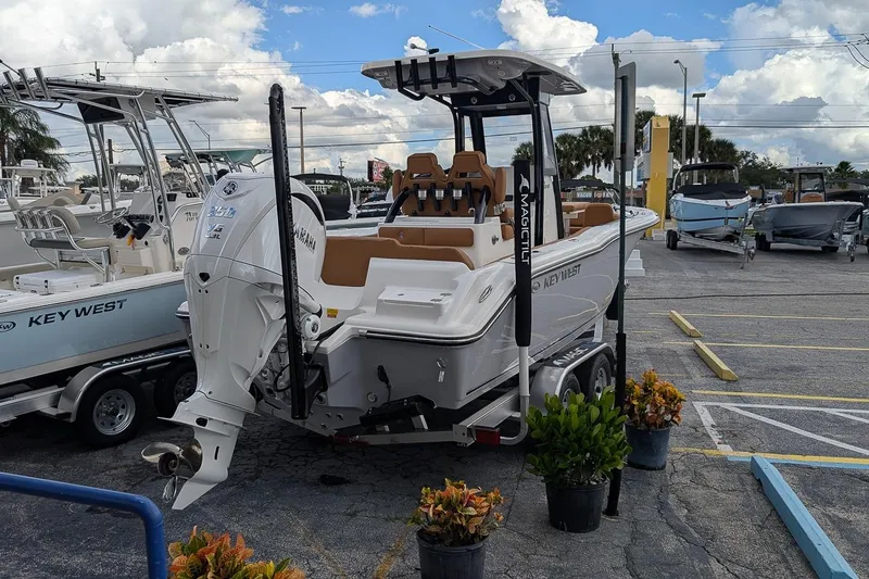 Slide: The Image of 2026 Key West 239 FSR boat on trailer in parking lot, surrounded by other boats. - 3
