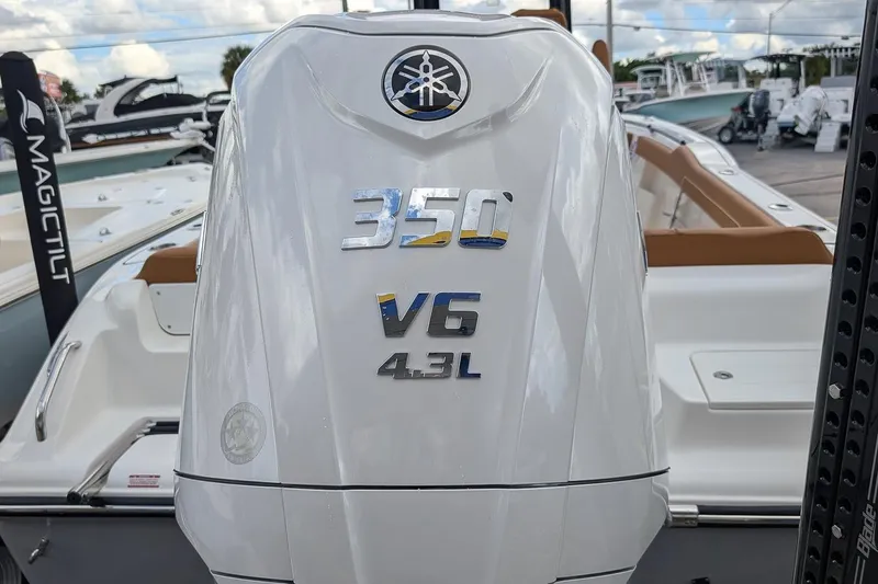 Slide: The Image of 2026 Key West 239 FSR boat with 350 V6 4.3L engine, docked outdoors. - 4