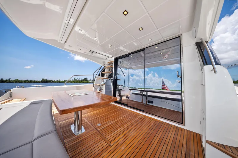 Slide: The Image of Luxurious 2017 Prestige 560 Flybridge yacht with sleek deck and elegant seating area. - 16