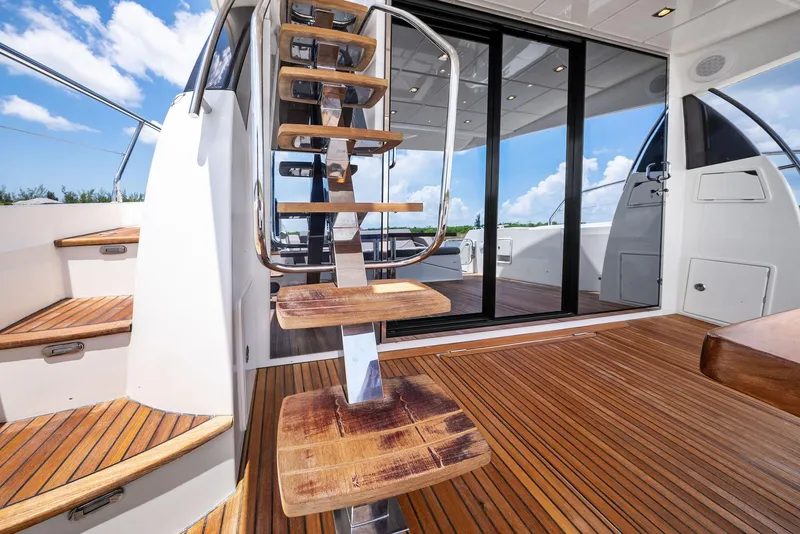 Slide: The Image of Prestige 560 Flybridge 2017 yacht with wooden deck and modern staircase. - 20