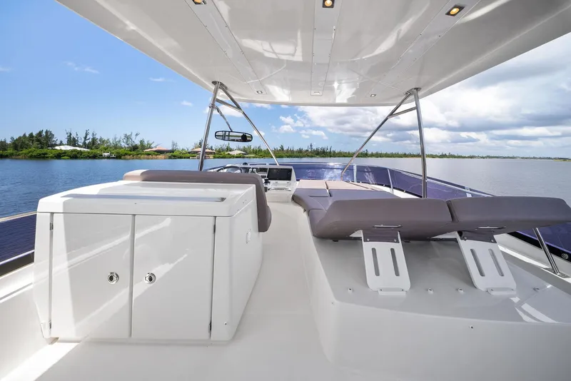 Slide: The Image of Luxurious 2017 Prestige 560 Flybridge yacht with spacious deck and seating, cruising on calm waters. - 21