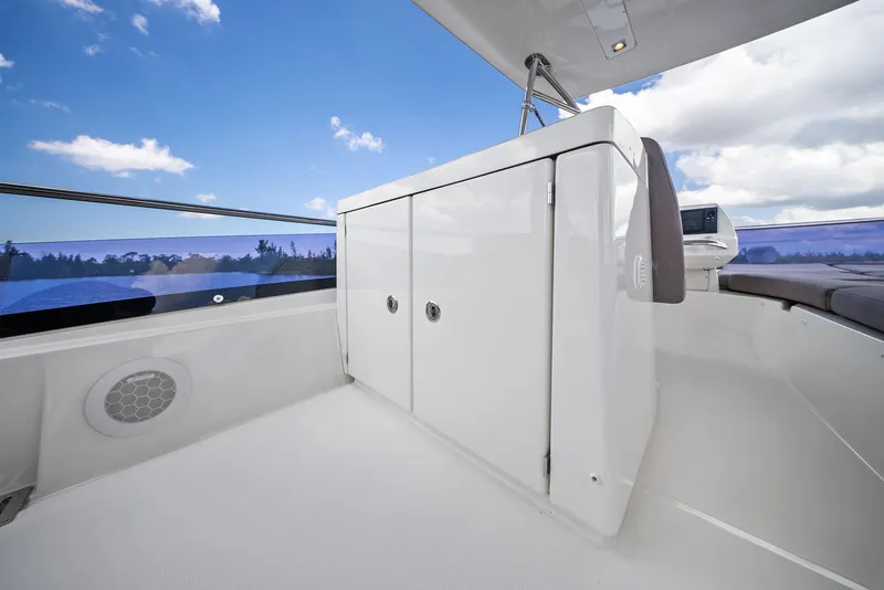 Slide: The Image of Prestige 560 Flybridge 2017 yacht deck with storage cabinet under clear blue sky. - 22